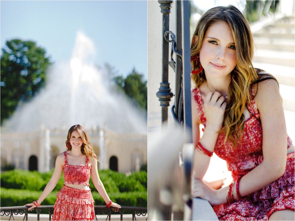 Claire posed in front of a fountain erupting in the background and leaning on a wrought iron rail.