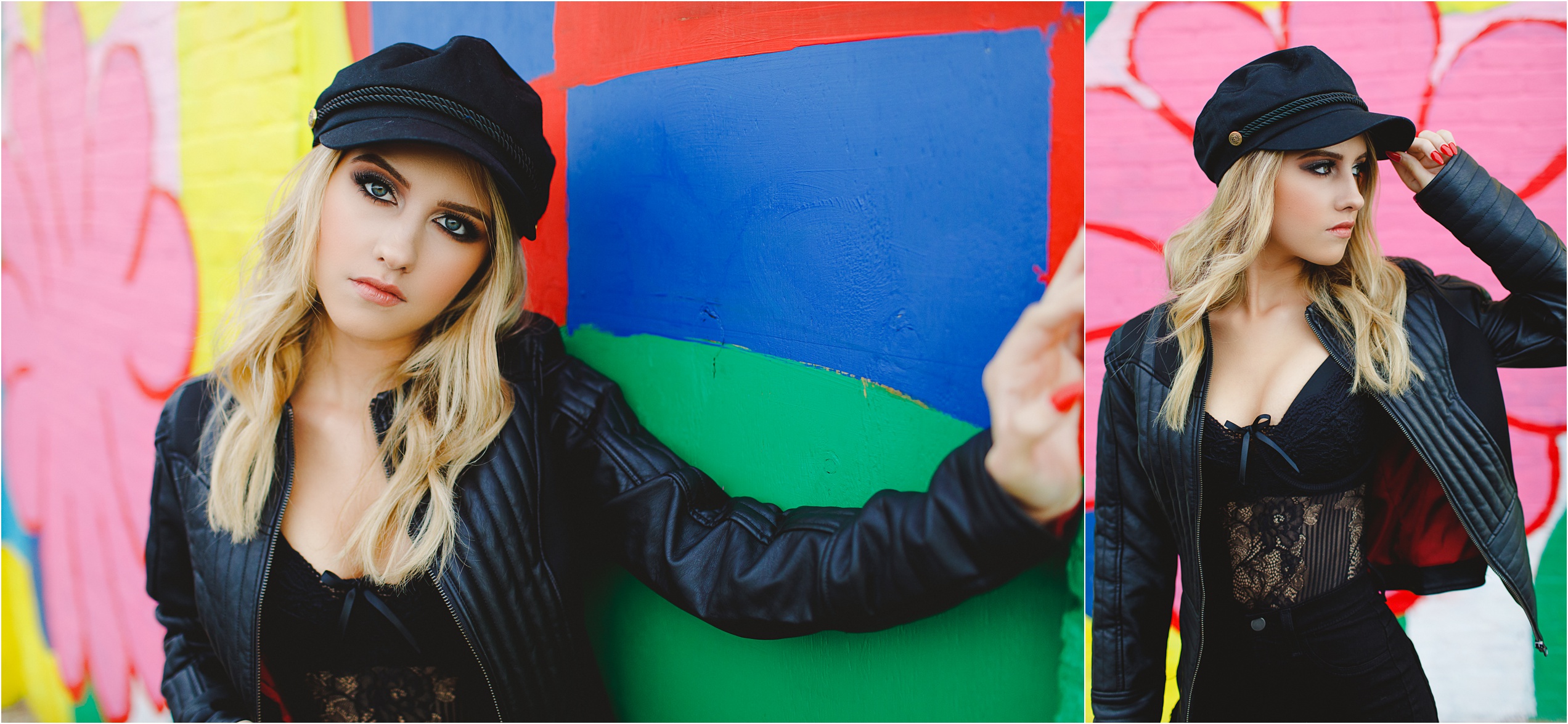 Andrina posing against the wall in an all black outfit in front of a colorful mural.